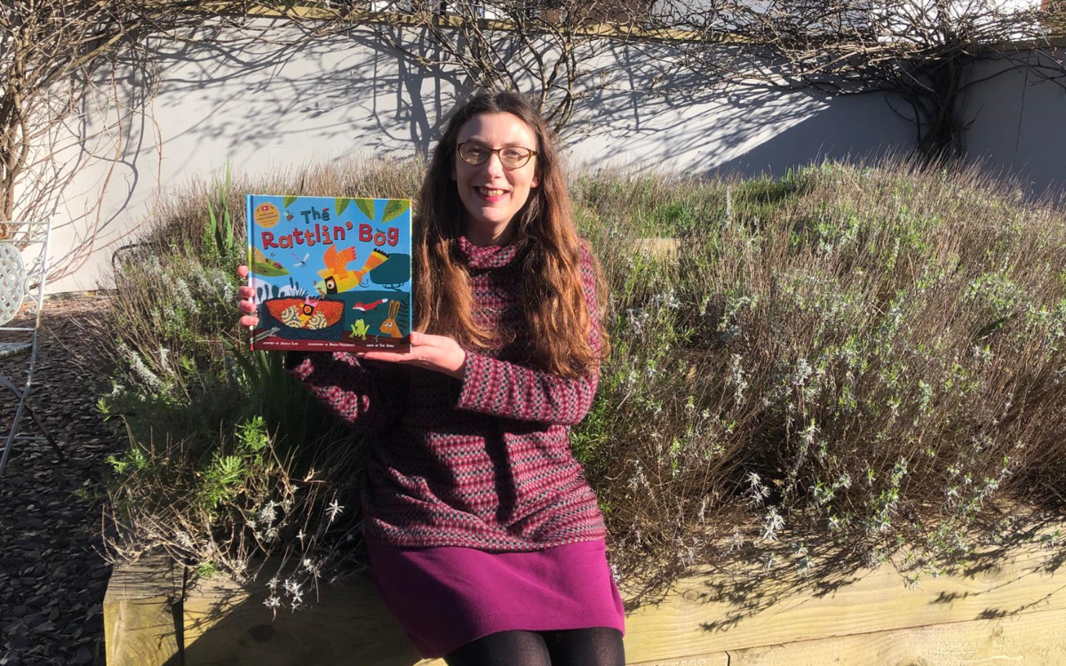 Author Jessica Law holding her new children's book, The Rattlin Bog